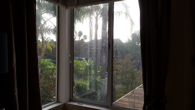 Picture of window before window cleaning in Newport Beach by Blue Coast Window Cleaning Service.